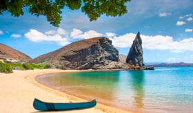 Galapagos Islands. Ecuador. Bartolome Island. Pinnacle Rock. Rocks in the water next to the sandy beach. Blue lagoon. Landscapes of the Galapagos.